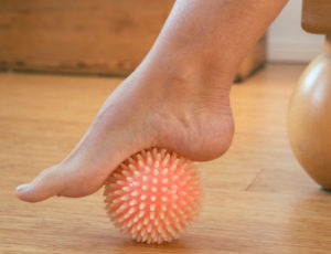 foot with prickly massage ball