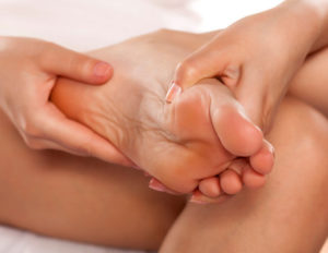 woman massaging her tired feet
